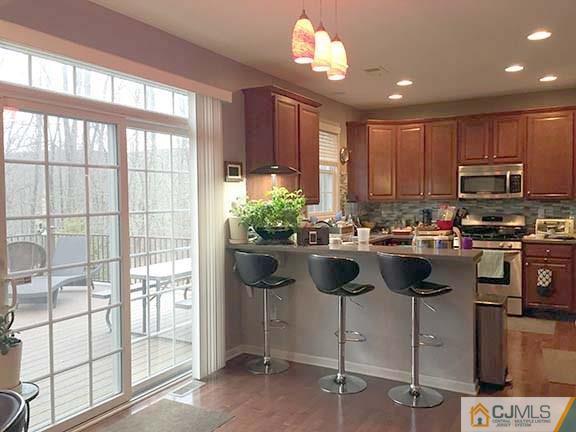 21 Frances Road Edison, NJ 08820 - Photo 20 of 20 a kitchen with kitchen island granite countertop a stove a sink and a microwave