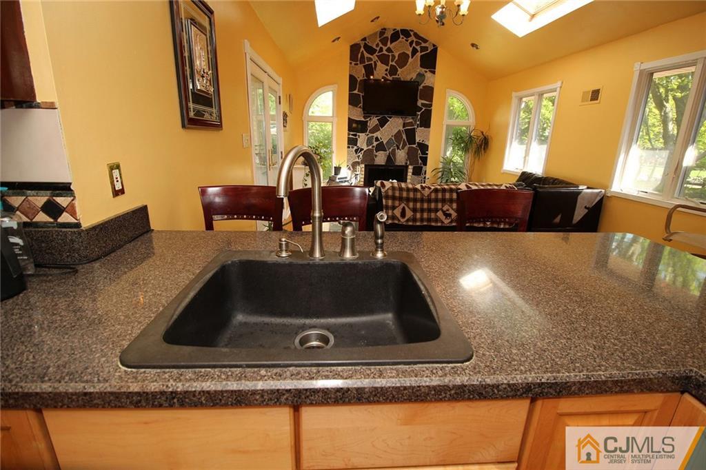 21 Frances Road Edison, NJ 08820 - Photo 3 of 20 a kitchen counter top space with granite countertop a sink and a wooden floor