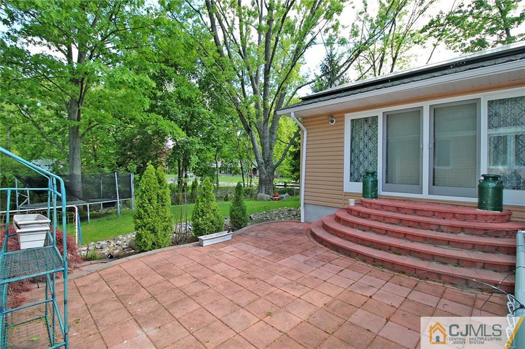21 Frances Road Edison, NJ 08820 - Photo 4 of 20 a backyard of a house with fountain table and chairs