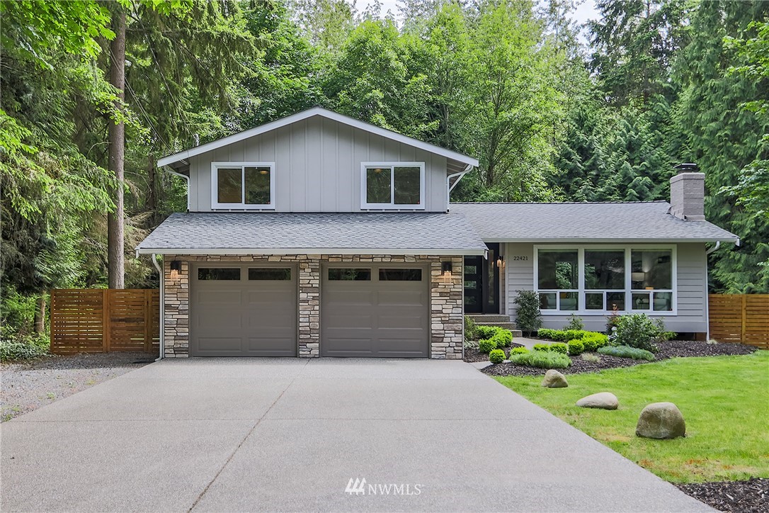 22421 53rd Avenue Southeast Bothell, WA 98021 - Photo 1 of 31 a front view of a house with a yard and garage