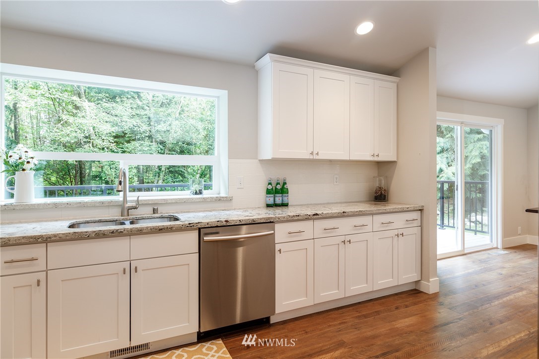 22421 53rd Avenue Southeast Bothell, WA 98021 - Photo 11 of 31 a kitchen with a sink stove and cabinets