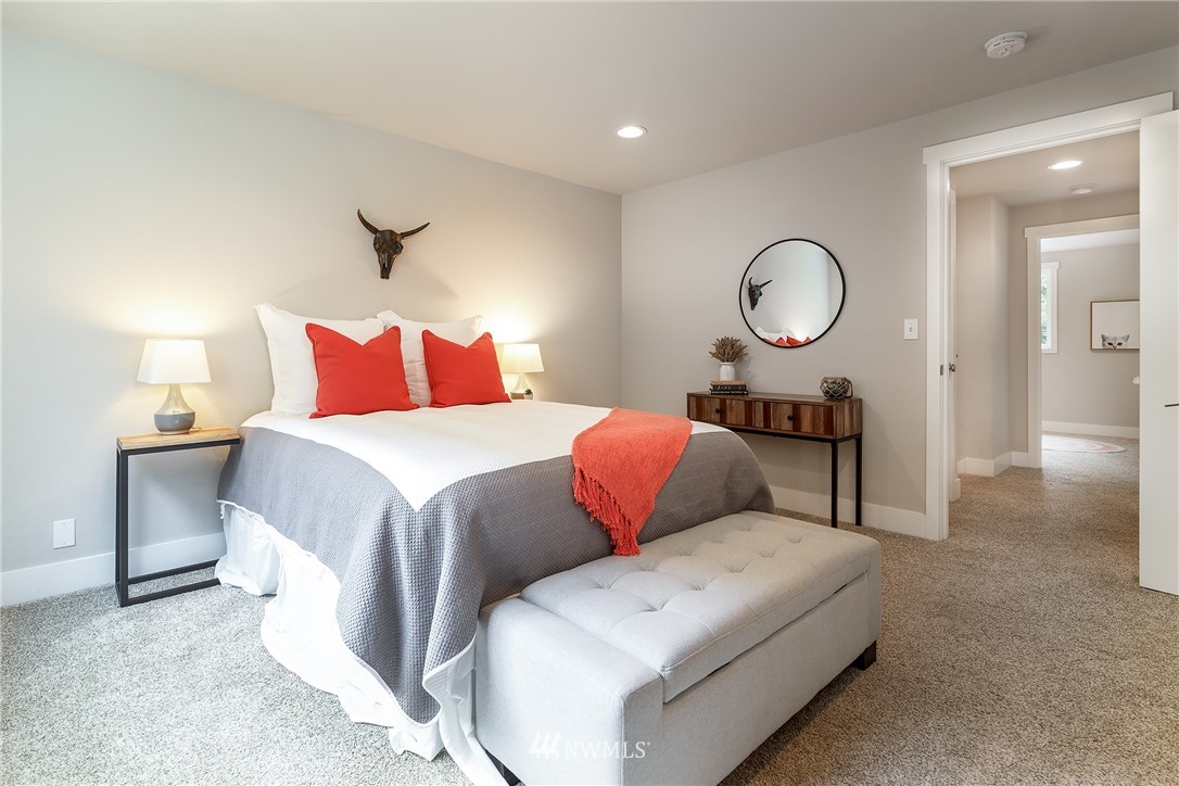 22421 53rd Avenue Southeast Bothell, WA 98021 - Photo 16 of 31 a bedroom with a bed and a chandelier
