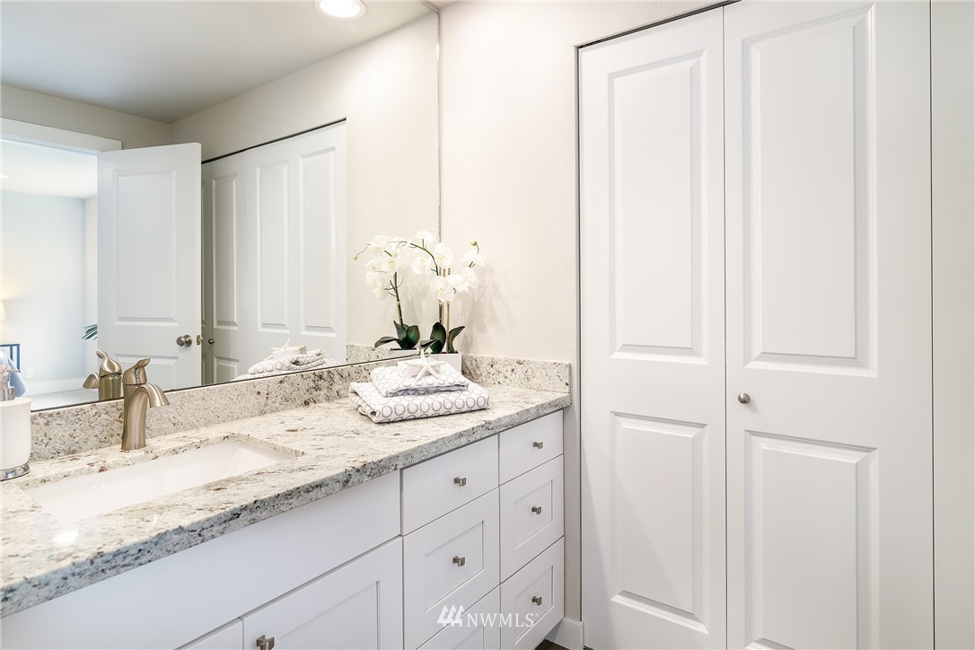 22421 53rd Avenue Southeast Bothell, WA 98021 - Photo 17 of 31 a bathroom with a granite countertop sink and a mirror