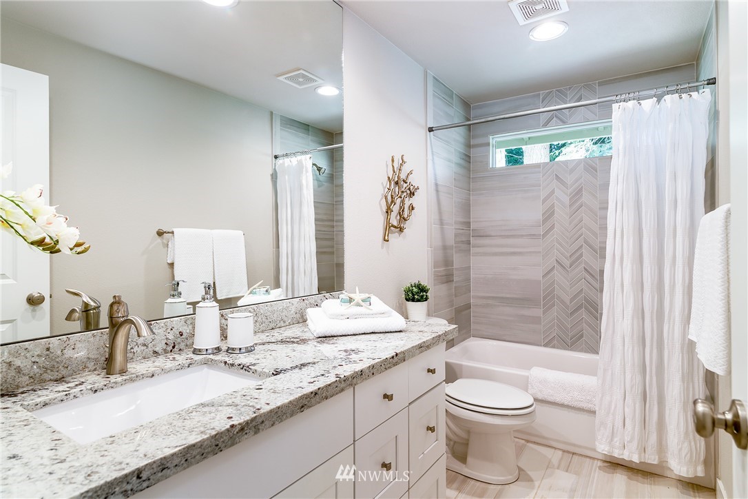 22421 53rd Avenue Southeast Bothell, WA 98021 - Photo 20 of 31 a bathroom with a granite countertop sink toilet and shower