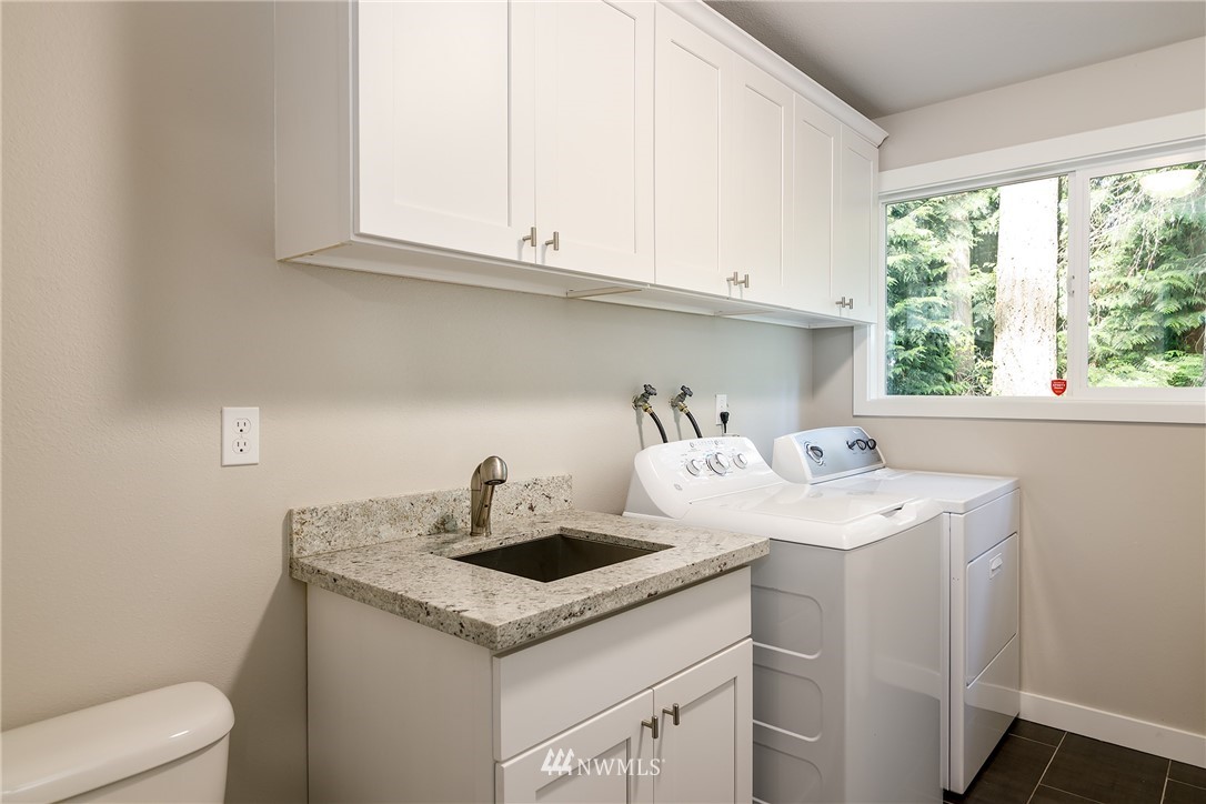 22421 53rd Avenue Southeast Bothell, WA 98021 - Photo 31 of 31 a utility room with sink dryer and washer
