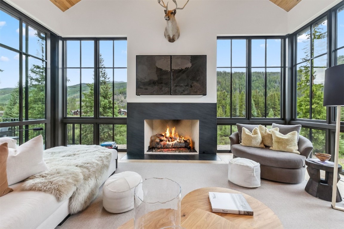 628 Independence Road Keystone, CO 80435 - Photo 4 of 50 a living room with furniture a floor to ceiling window and a fireplace