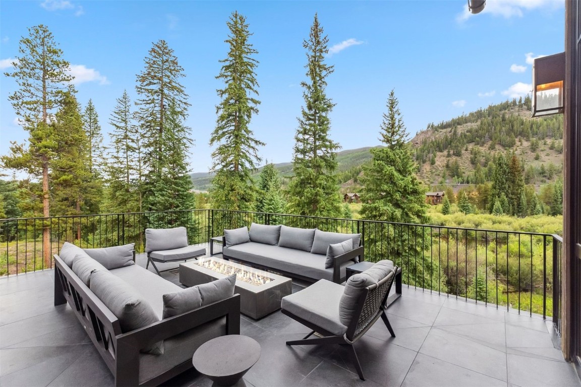 628 Independence Road Keystone, CO 80435 - Photo 6 of 50 a view of a patio with couches and a table and chairs with wooden floor