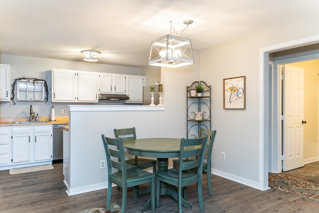 48 Evergreen Road, Unit 212 Leeds, MA 01053 - Photo 12 of 34 a view of a dining room with furniture and wooden floor