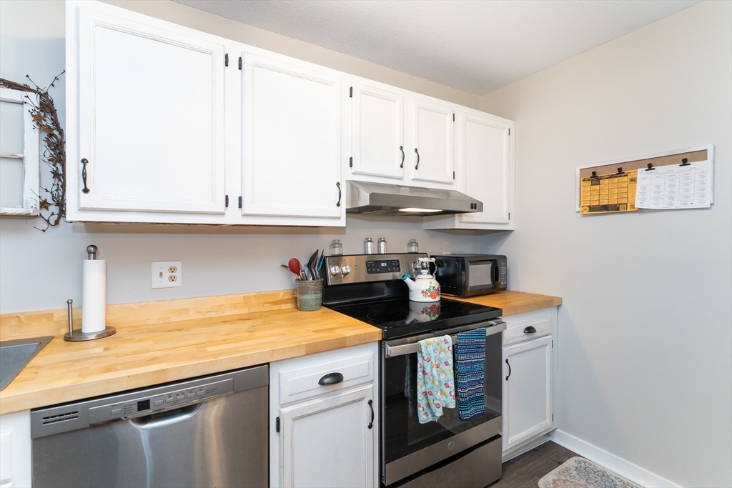 48 Evergreen Road, Unit 212 Leeds, MA 01053 - Photo 14 of 34 a kitchen with stainless steel appliances granite countertop a sink and cabinets