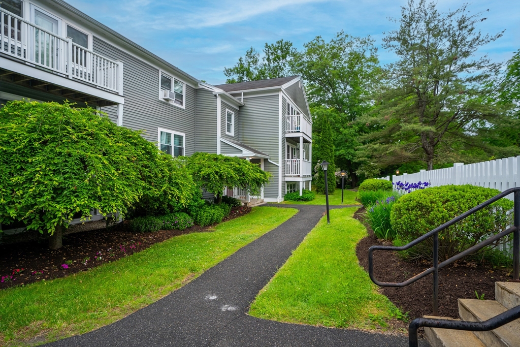 48 Evergreen Road, Unit 212 Leeds, MA 01053 - Photo 3 of 34 a view of a house with backyard and a garden
