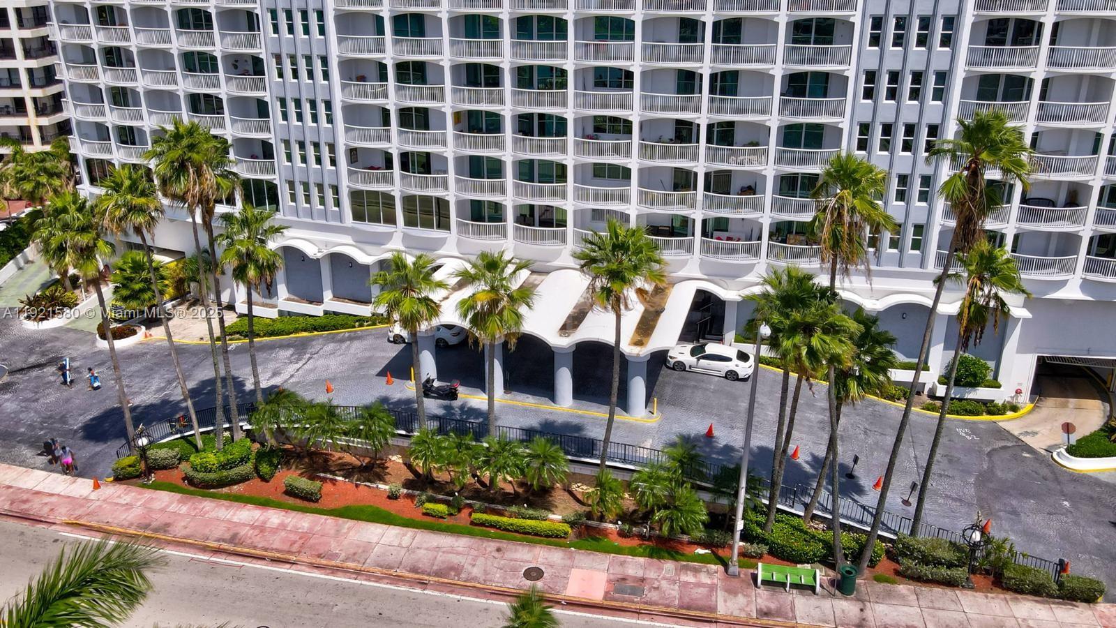 5401 Collins Avenue, Unit 340 Miami Beach, FL 33140 - Photo 13 of 54 front view of building with glass windows