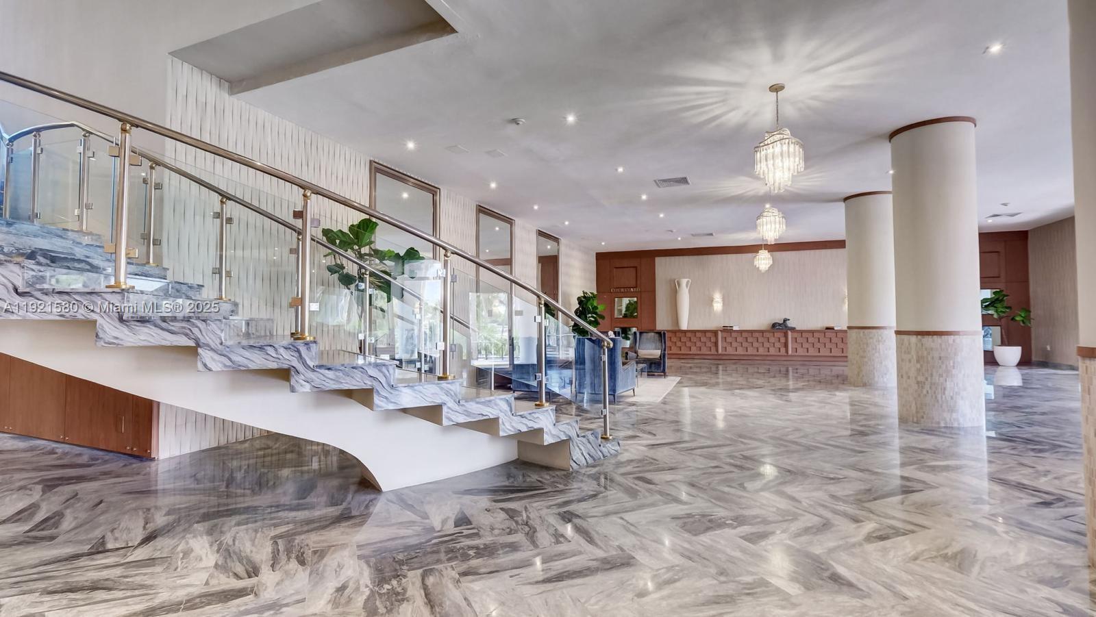 5401 Collins Avenue, Unit 340 Miami Beach, FL 33140 - Photo 17 of 54 a living room with couches and kitchen view with wooden floor