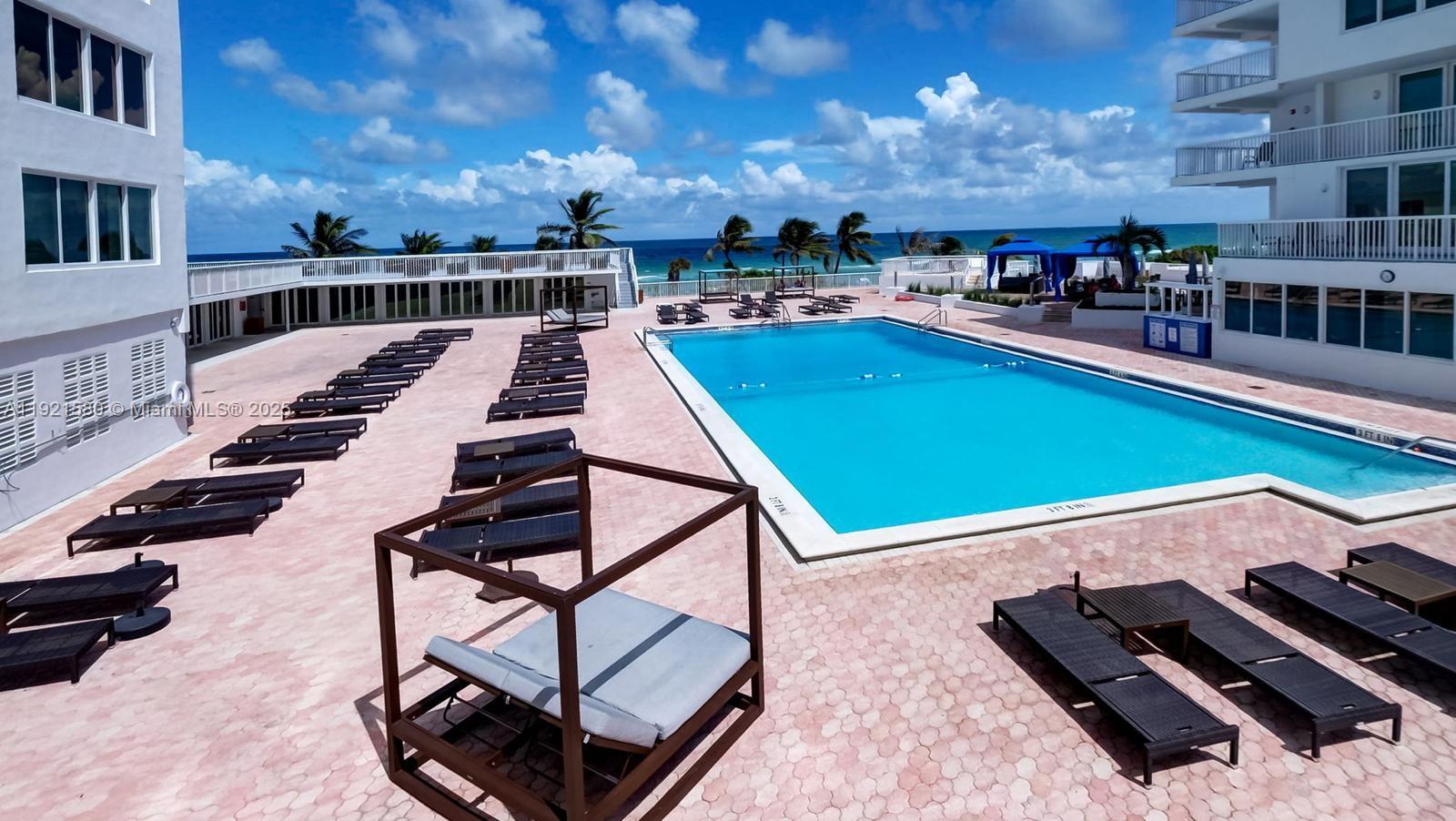 5401 Collins Avenue, Unit 340 Miami Beach, FL 33140 - Photo 23 of 54 a view of a swimming pool with seating area