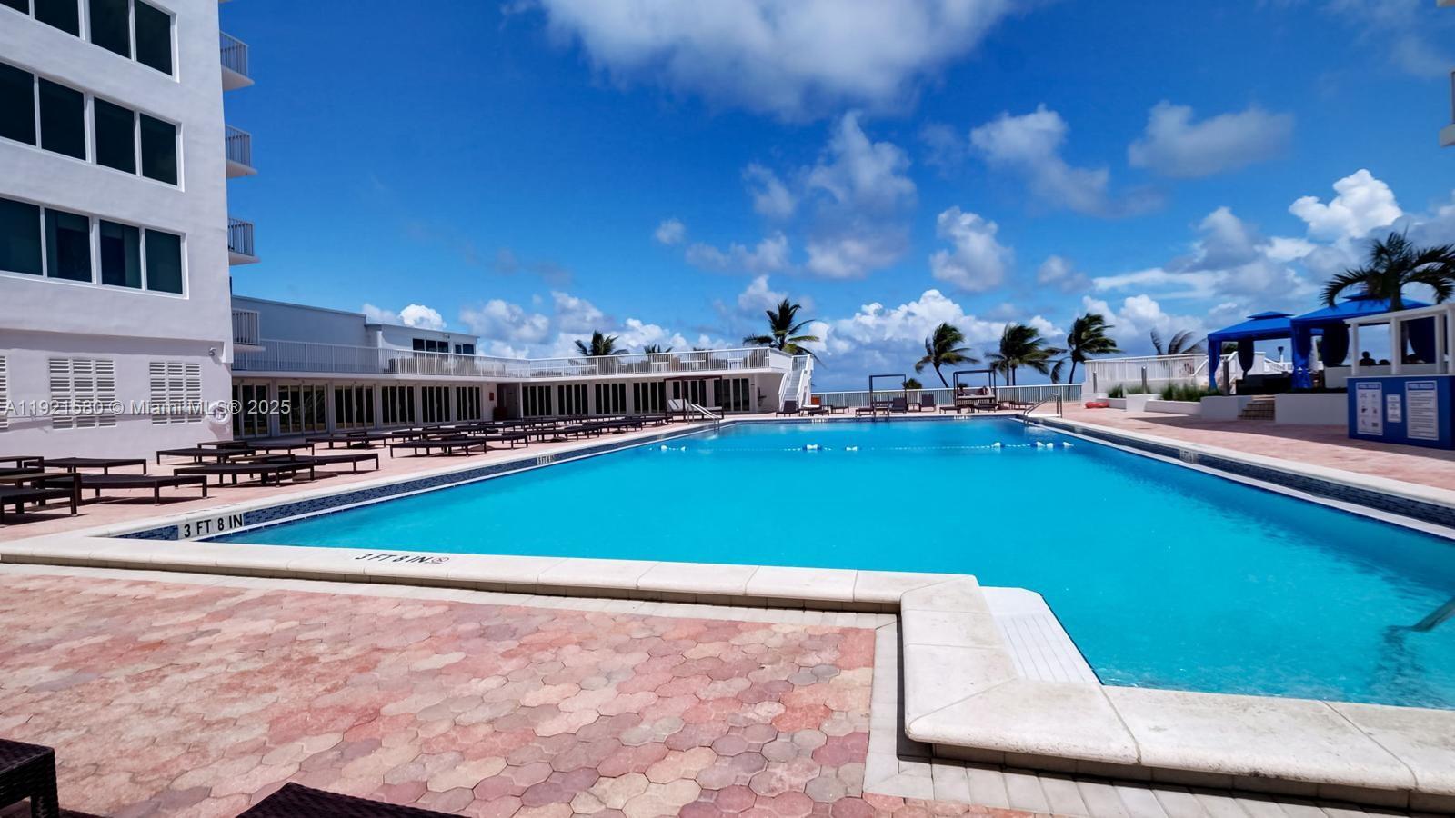 5401 Collins Avenue, Unit 340 Miami Beach, FL 33140 - Photo 24 of 54 a view of a swimming pool with outdoor seating