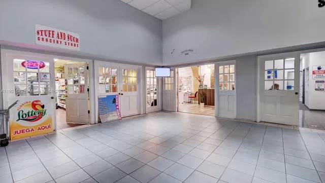 a spacious bedroom with a bed and glass door