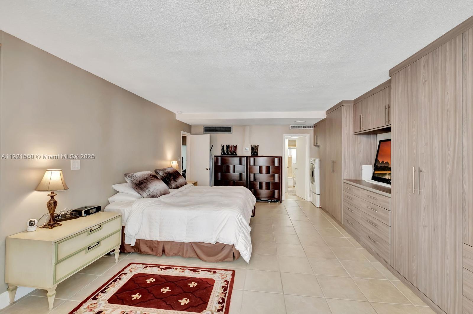 5401 Collins Avenue, Unit 340 Miami Beach, FL 33140 - Photo 37 of 54 a bed room with a bed and a walk in closet