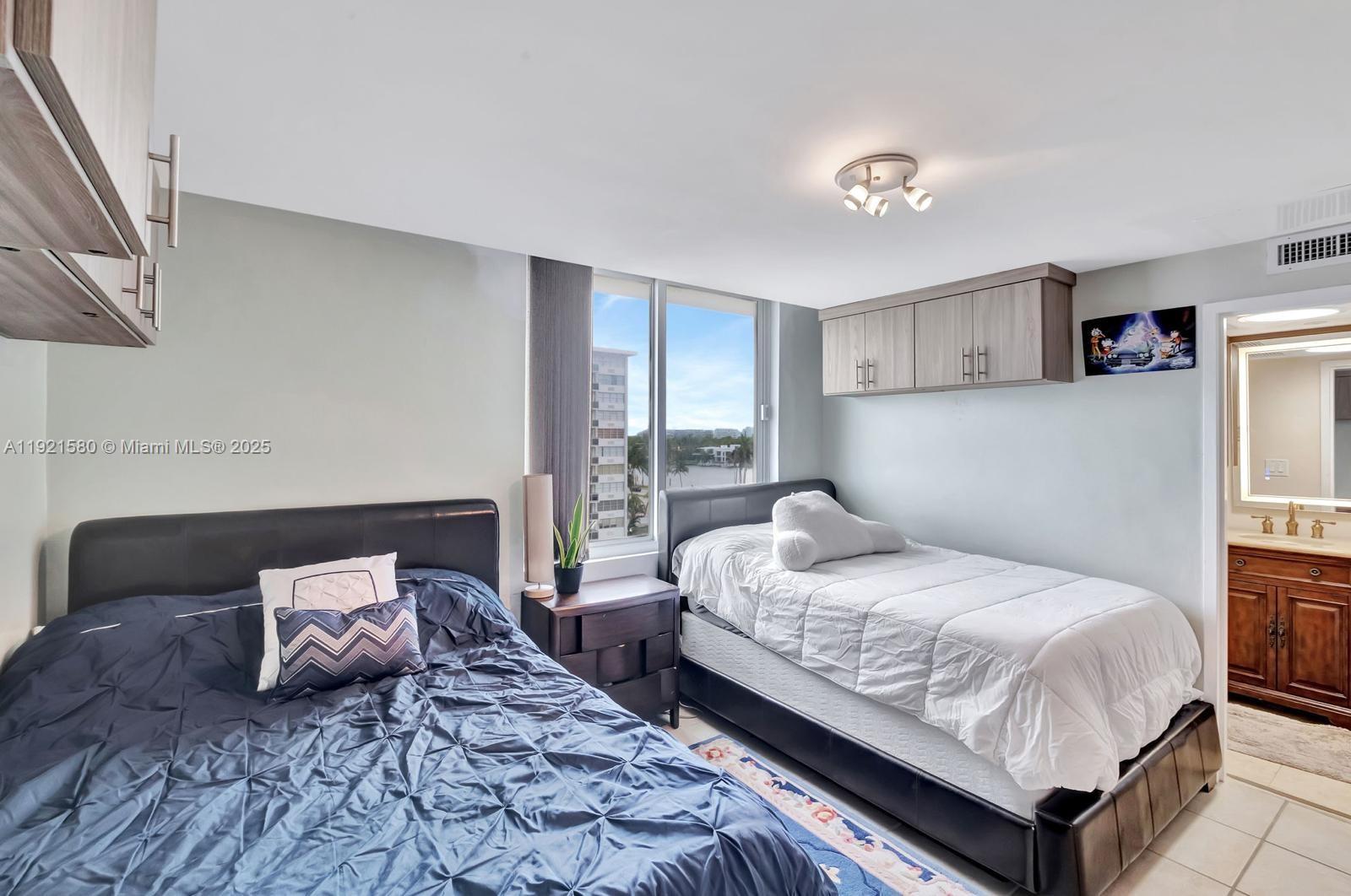 5401 Collins Avenue, Unit 340 Miami Beach, FL 33140 - Photo 40 of 54 a bedroom with a bed and a couch