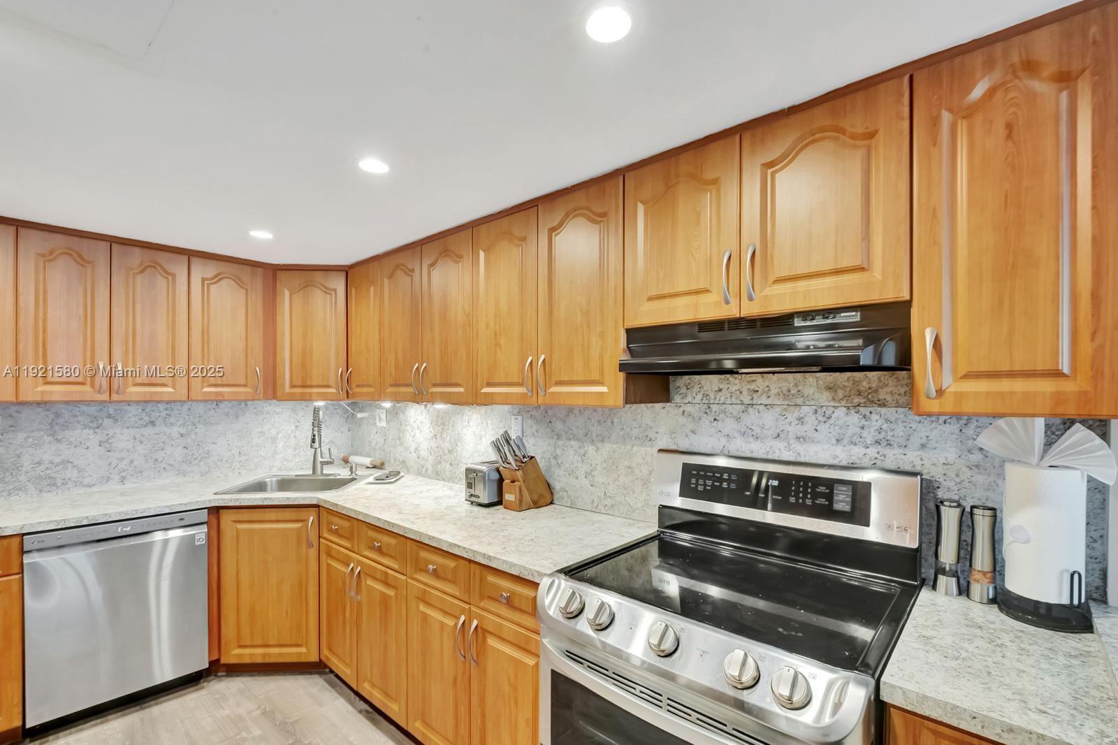 5401 Collins Avenue, Unit 340 Miami Beach, FL 33140 - Photo 42 of 54 a kitchen with granite countertop cabinets stainless steel appliances and a sink