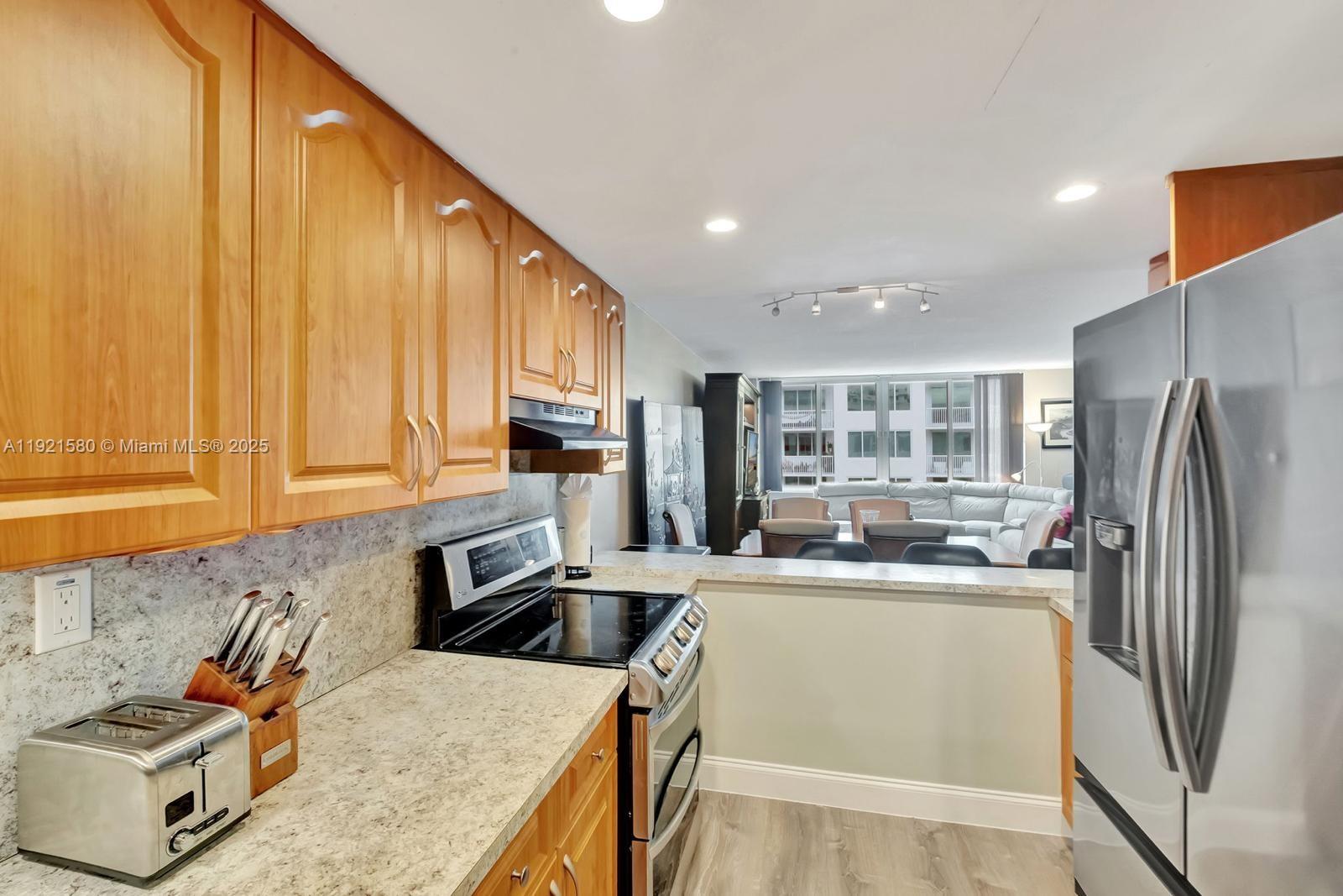 5401 Collins Avenue, Unit 340 Miami Beach, FL 33140 - Photo 44 of 54 a kitchen with a stove a refrigerator and a sink