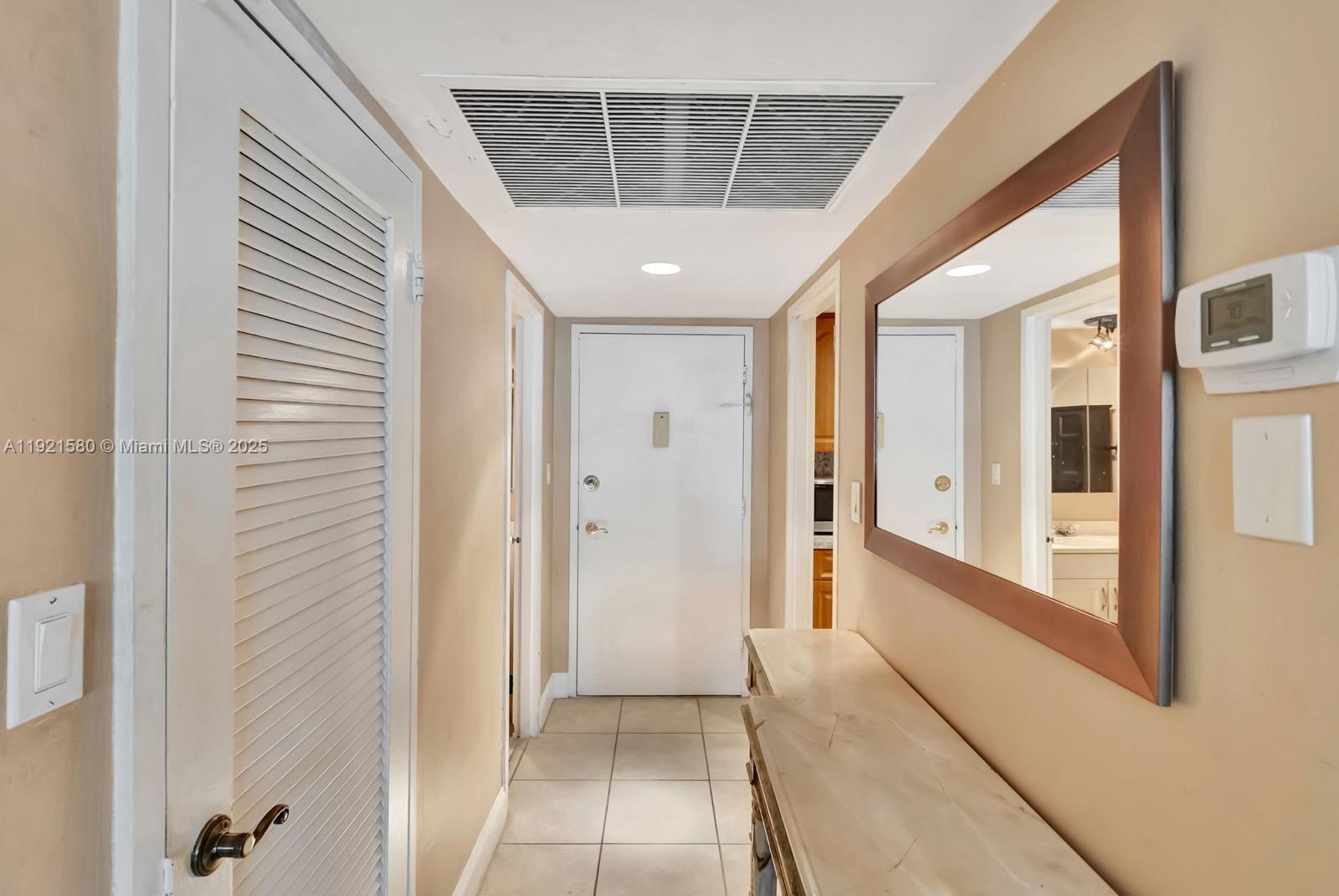 5401 Collins Avenue, Unit 340 Miami Beach, FL 33140 - Photo 52 of 54 a view of a hallway with wooden floor and entryway