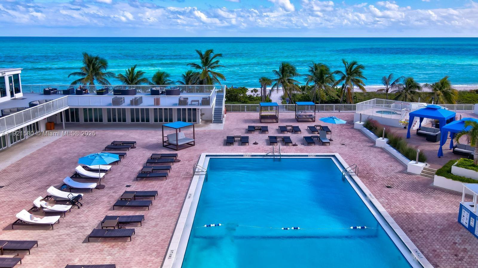5401 Collins Avenue, Unit 340 Miami Beach, FL 33140 - Photo 10 of 54 a view of a swimming pool with furniture