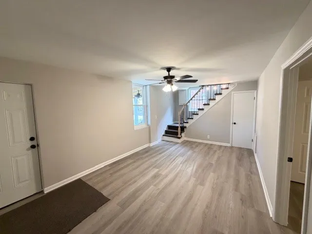 wooden floor in an empty room with a window