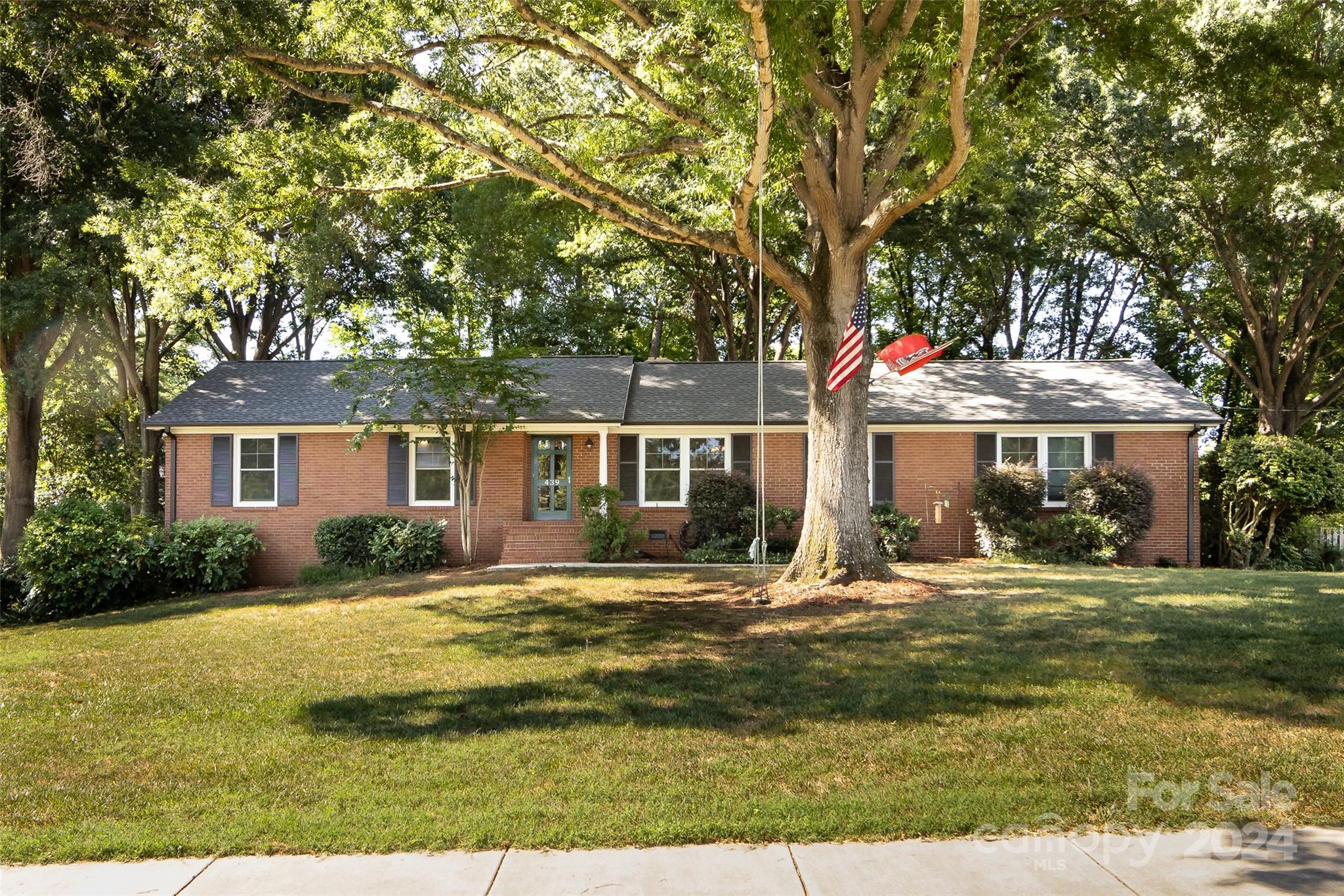 a front view of a house with yard porch and outdoor seating