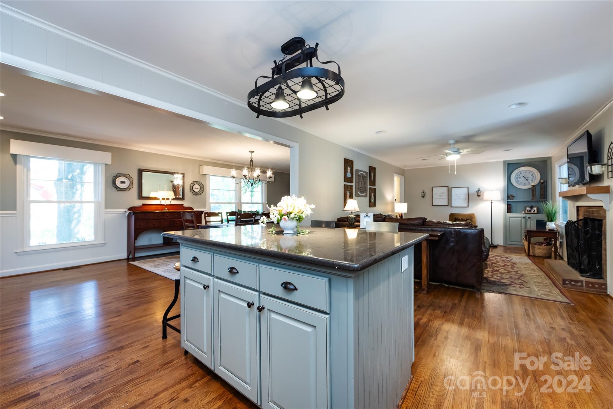 439 Boyce Road Charlotte, NC 28211 - Photo 11 of 47 a kitchen with kitchen island granite countertop a sink cabinets and wooden floor