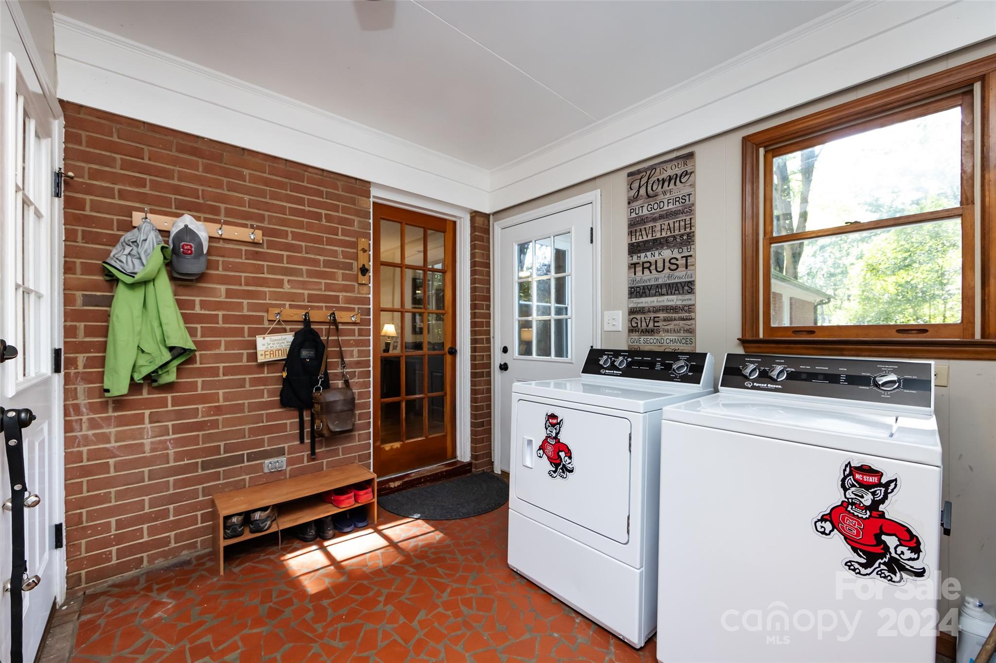 439 Boyce Road Charlotte, NC 28211 - Photo 14 of 47 a utility room with fridge and window
