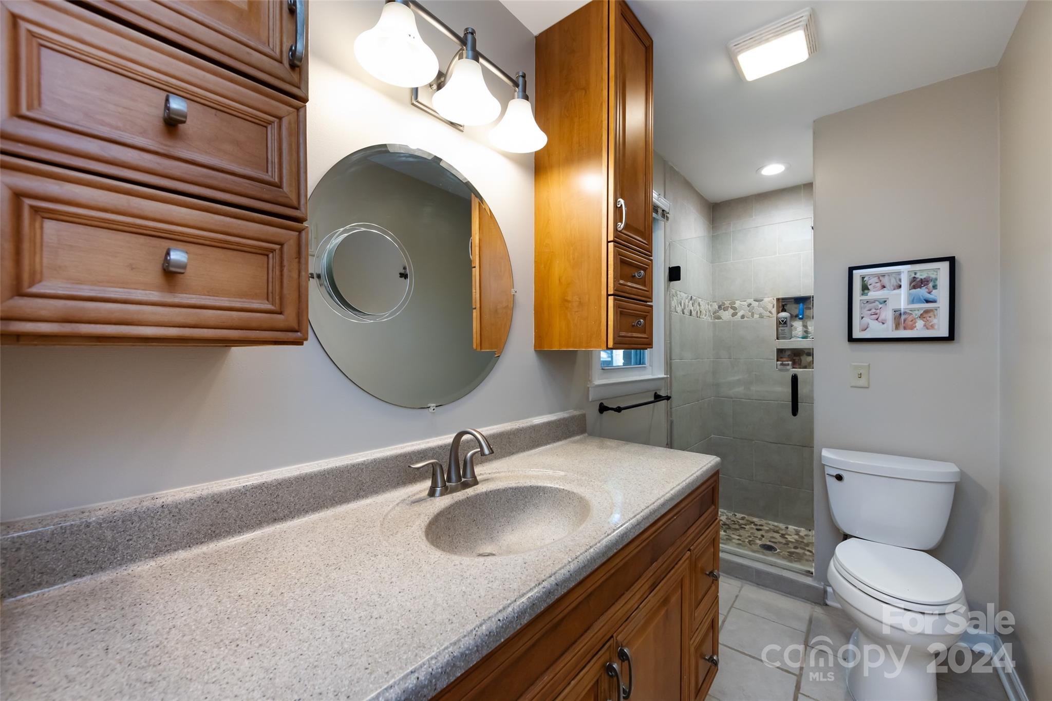 439 Boyce Road Charlotte, NC 28211 - Photo 18 of 47 a bathroom with a toilet sink and mirror