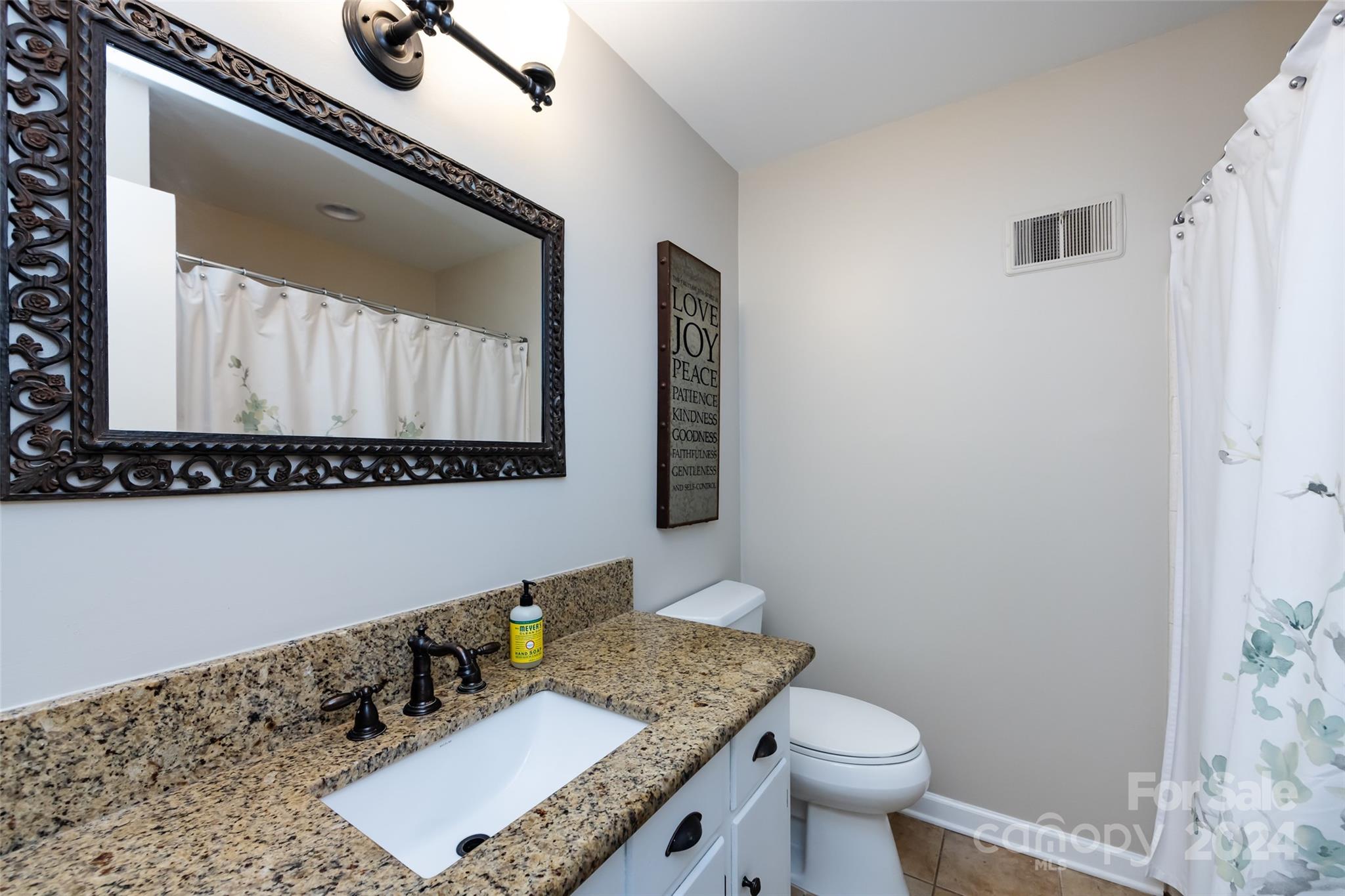 439 Boyce Road Charlotte, NC 28211 - Photo 23 of 47 a bathroom with a granite countertop sink and a mirror