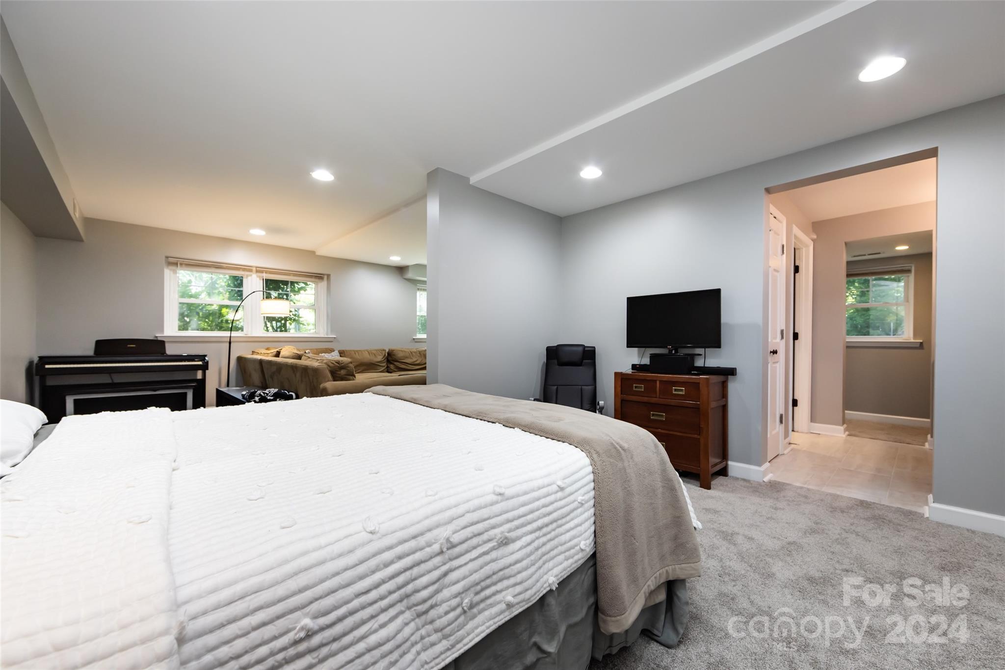 439 Boyce Road Charlotte, NC 28211 - Photo 31 of 47 a large bedroom with a bed and a flat screen tv