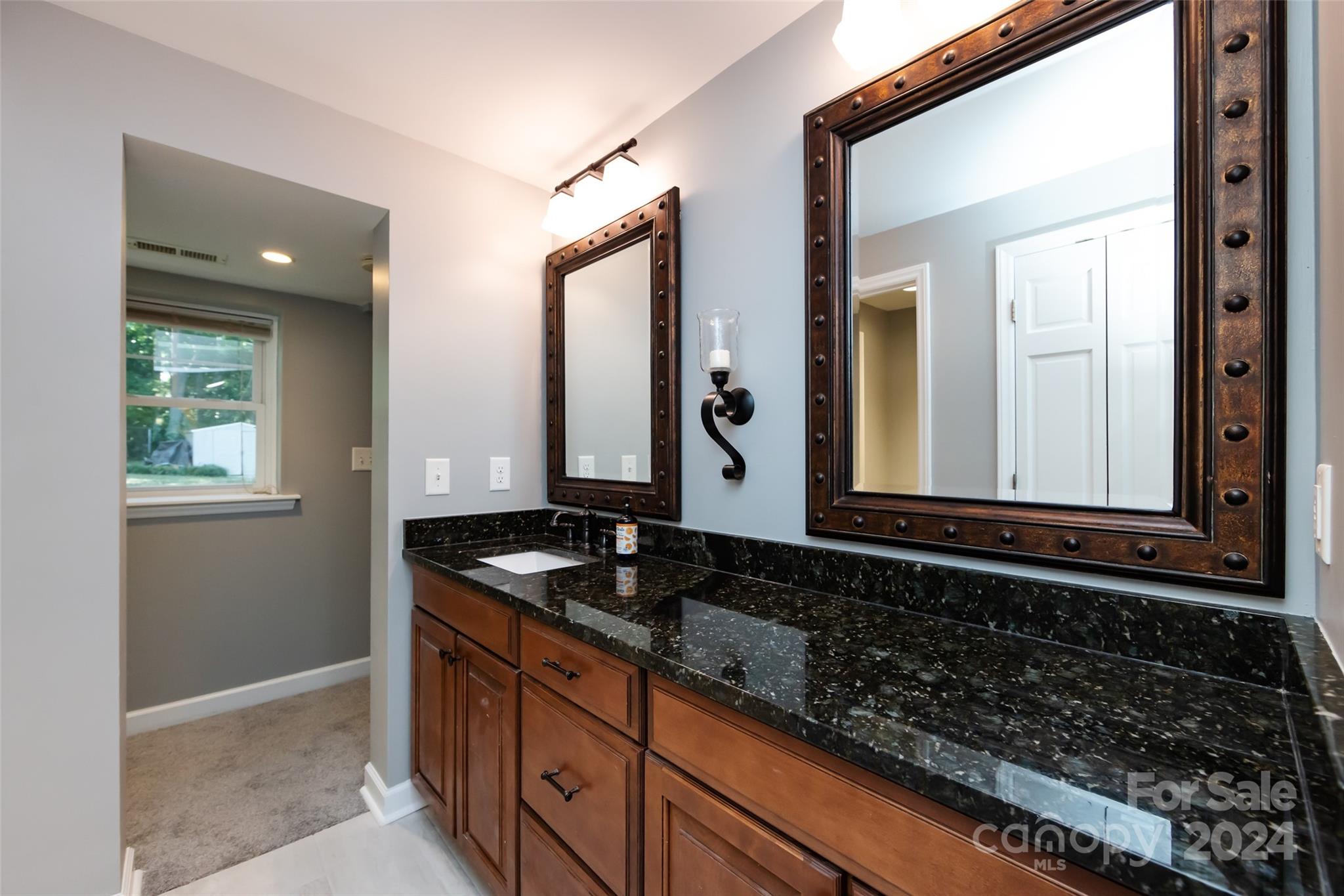 439 Boyce Road Charlotte, NC 28211 - Photo 32 of 47 a bathroom with a granite countertop sink and a mirror