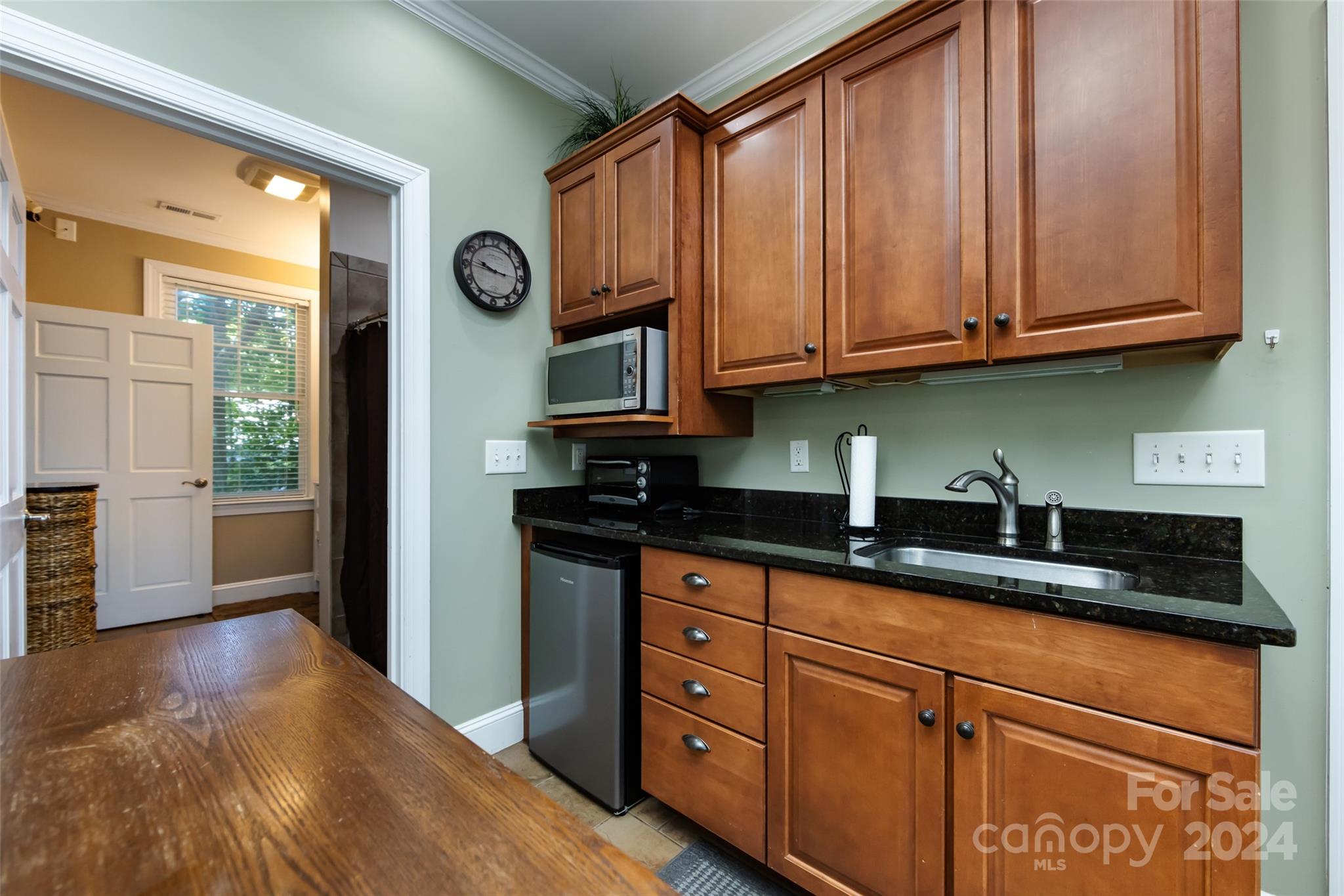 439 Boyce Road Charlotte, NC 28211 - Photo 37 of 47 a kitchen with granite countertop wooden cabinets stainless steel appliances and a window