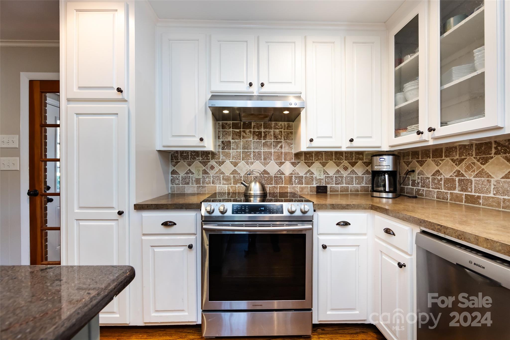439 Boyce Road Charlotte, NC 28211 - Photo 10 of 47 a kitchen with granite countertop a stove sink and cabinets
