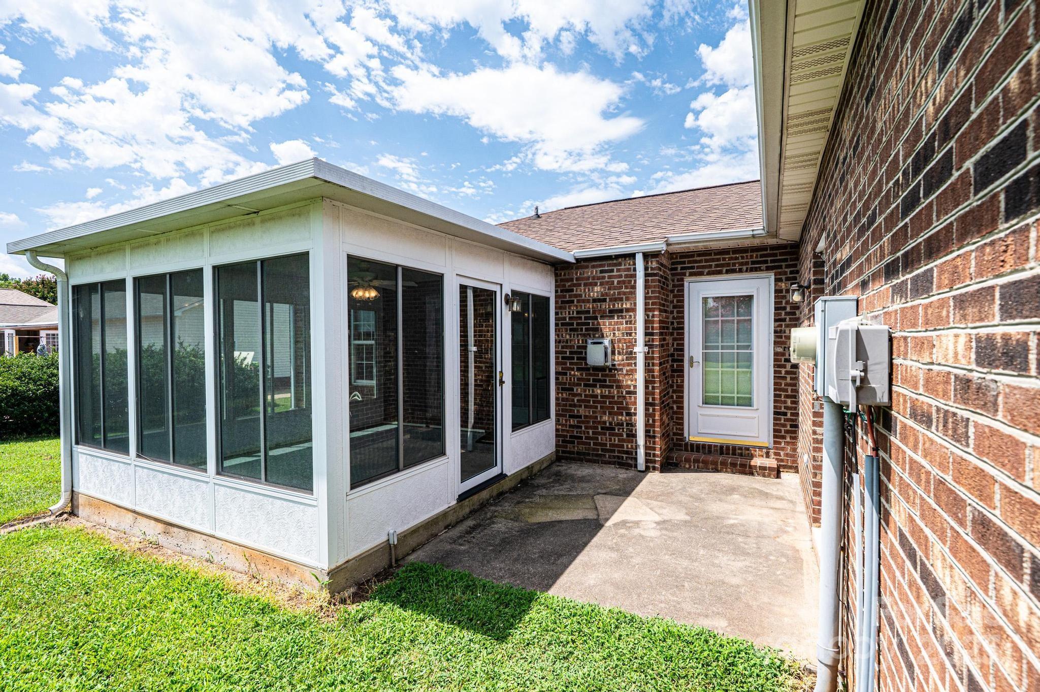 3808 River Road Hickory, NC 28602 - Photo 6 of 40 a view of a house with a large window and wooden fence
