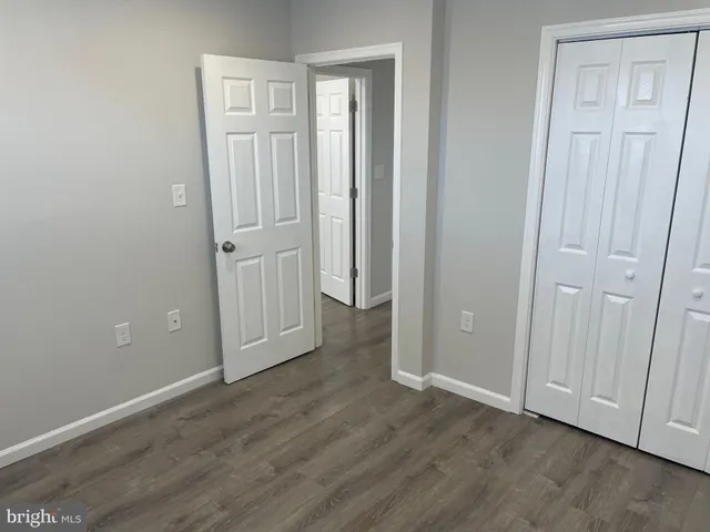 an empty room with wooden floor