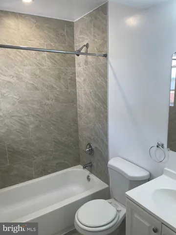 a bathroom with a toilet and a bath tub