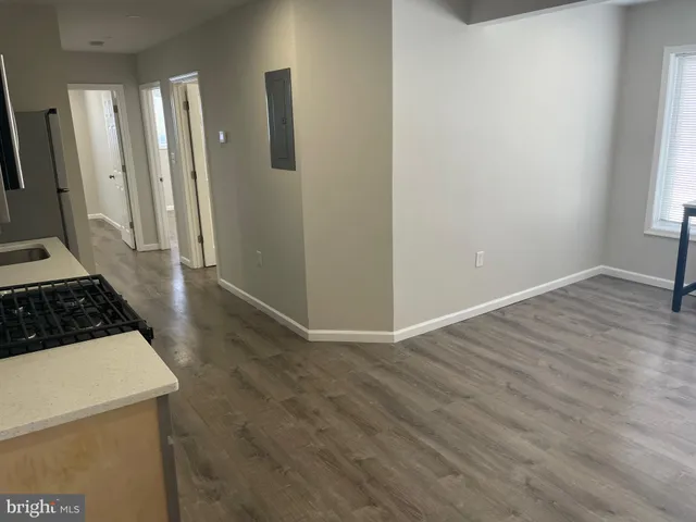 a view of a utility room with wooden floor and a sink