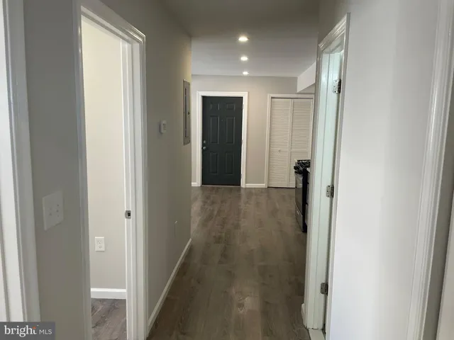 a view of a hallway with wooden floor