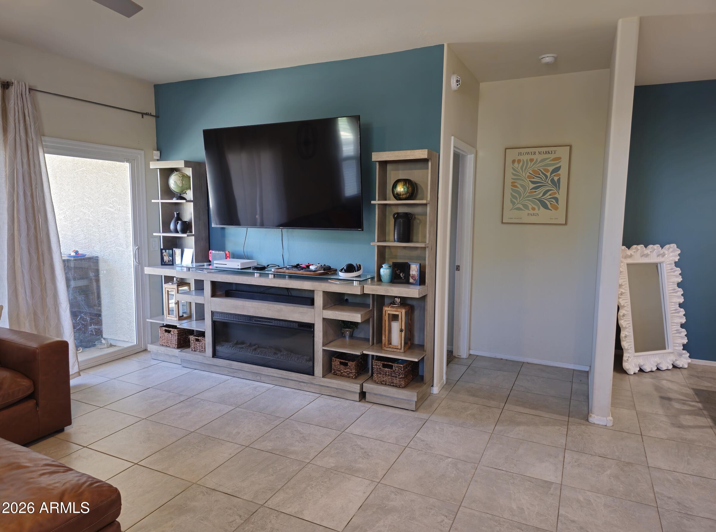 9434 Cotton Road Florence, AZ 85132 - Photo 9 of 25 a living room with furniture and a flat screen tv