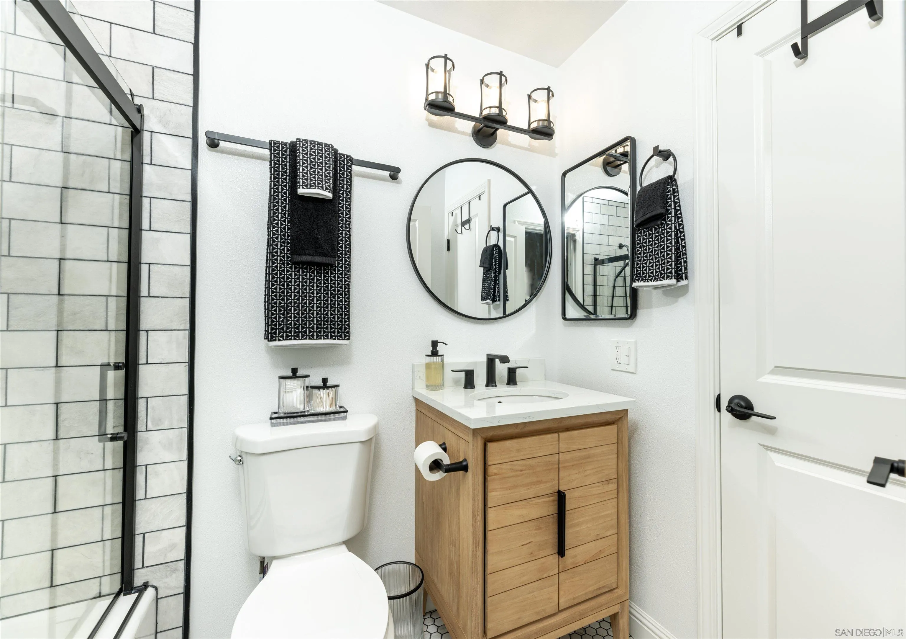 3550 Ruffin Road, Unit 155 San Diego, CA 92123 - Photo 18 of 25 a bathroom with a toilet sink and mirror