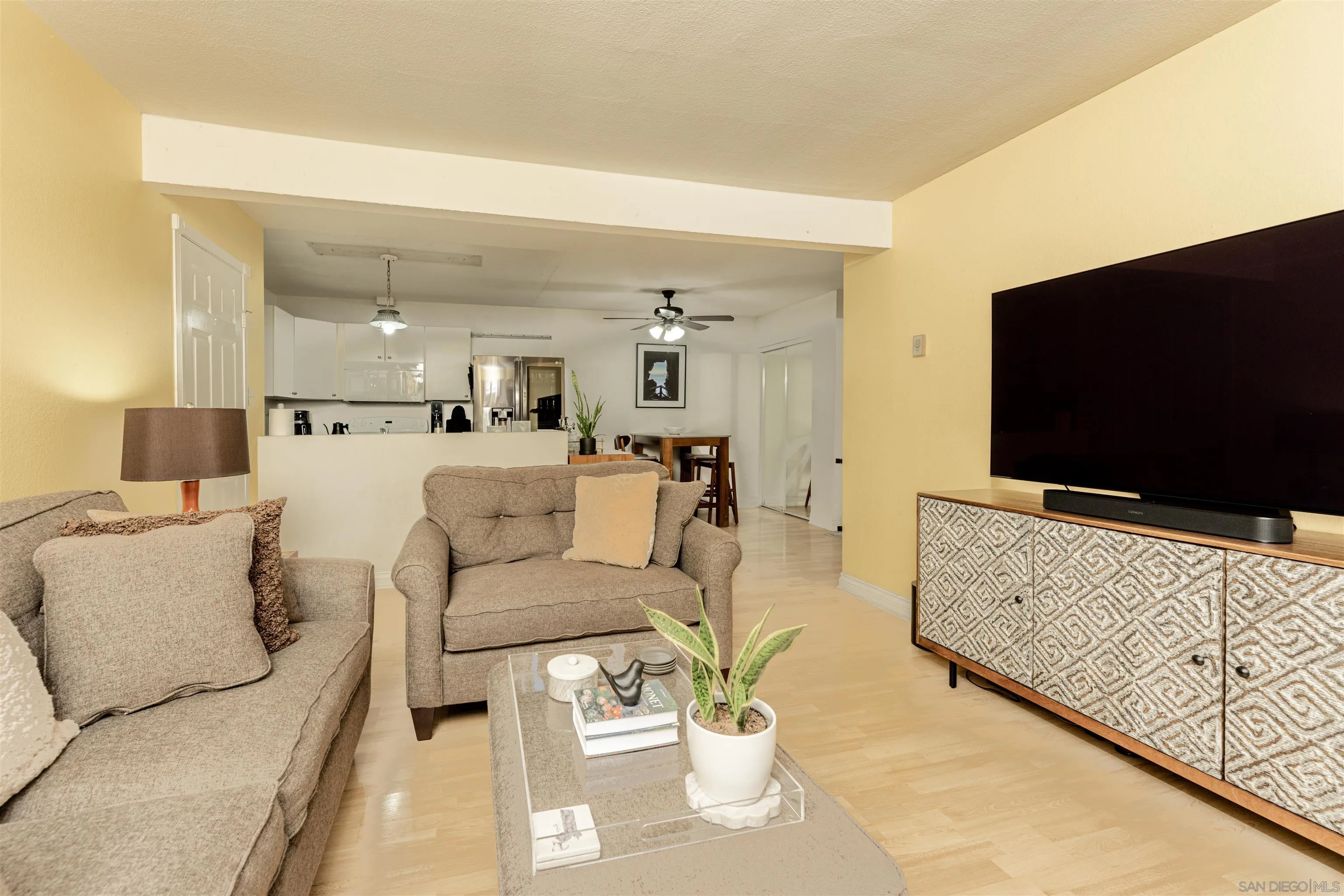 3550 Ruffin Road, Unit 155 San Diego, CA 92123 - Photo 2 of 25 a living room with furniture and a flat screen tv