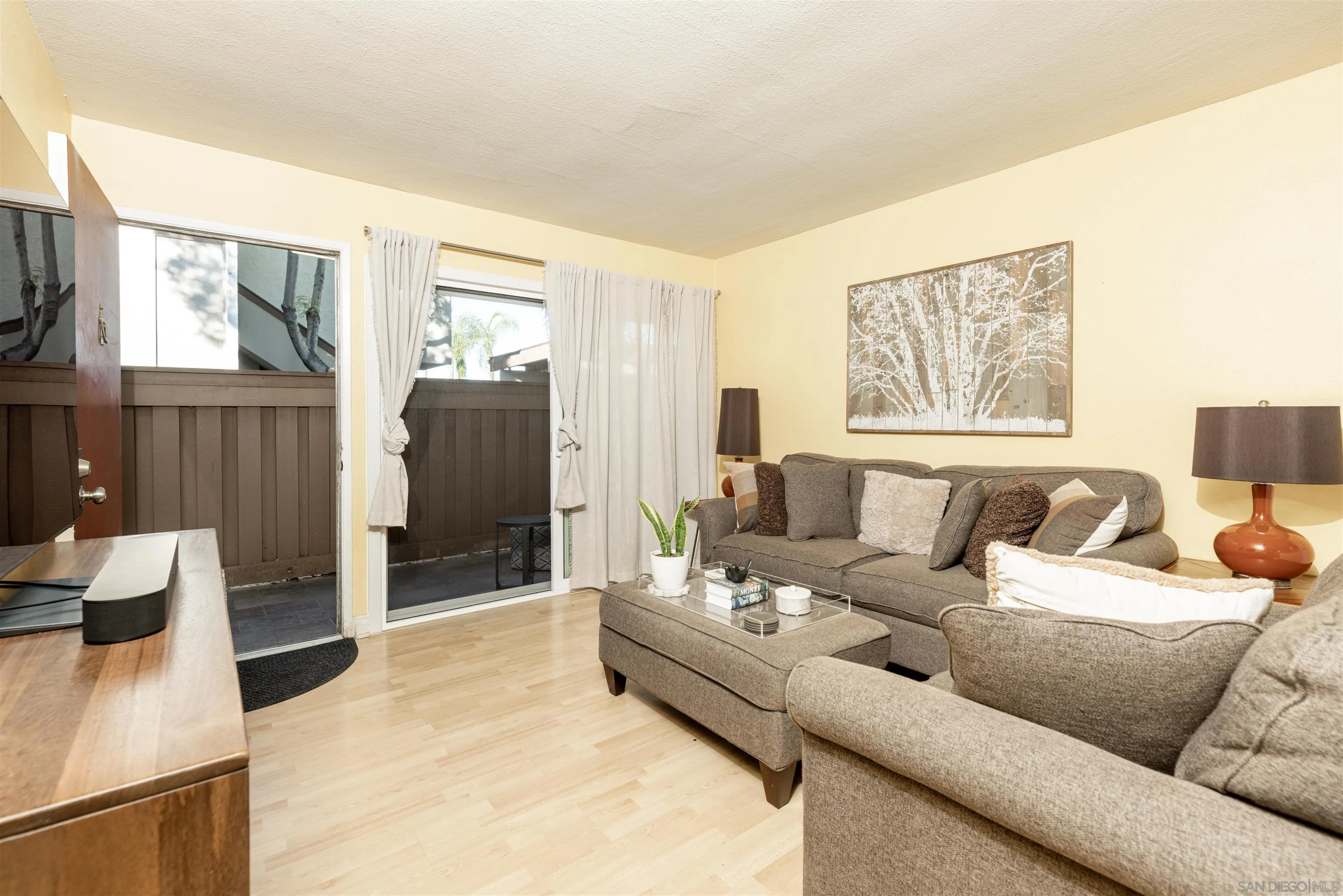 3550 Ruffin Road, Unit 155 San Diego, CA 92123 - Photo 4 of 25 a living room with furniture and a flat screen tv