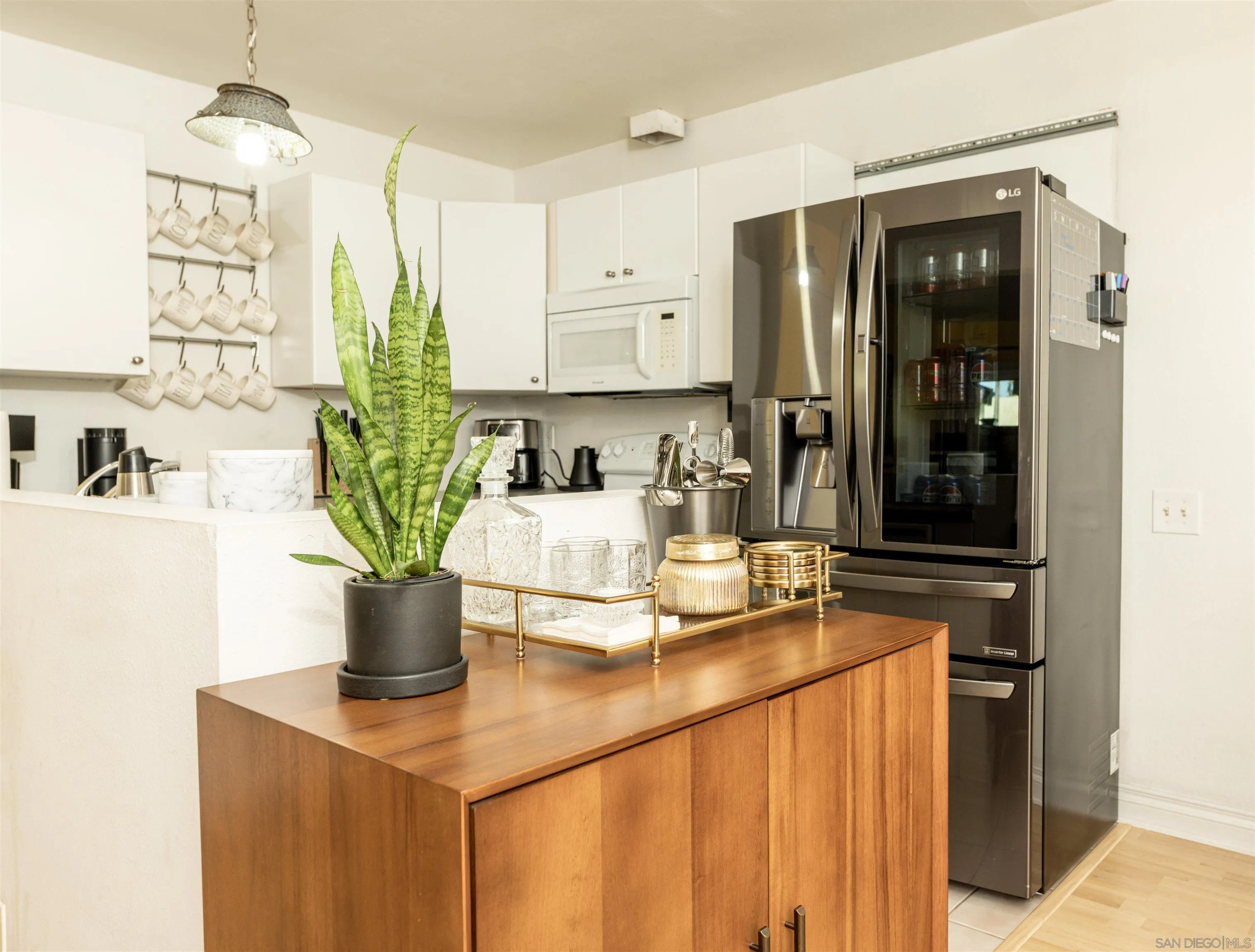 3550 Ruffin Road, Unit 155 San Diego, CA 92123 - Photo 5 of 25 a kitchen with a two appliances and cabinets