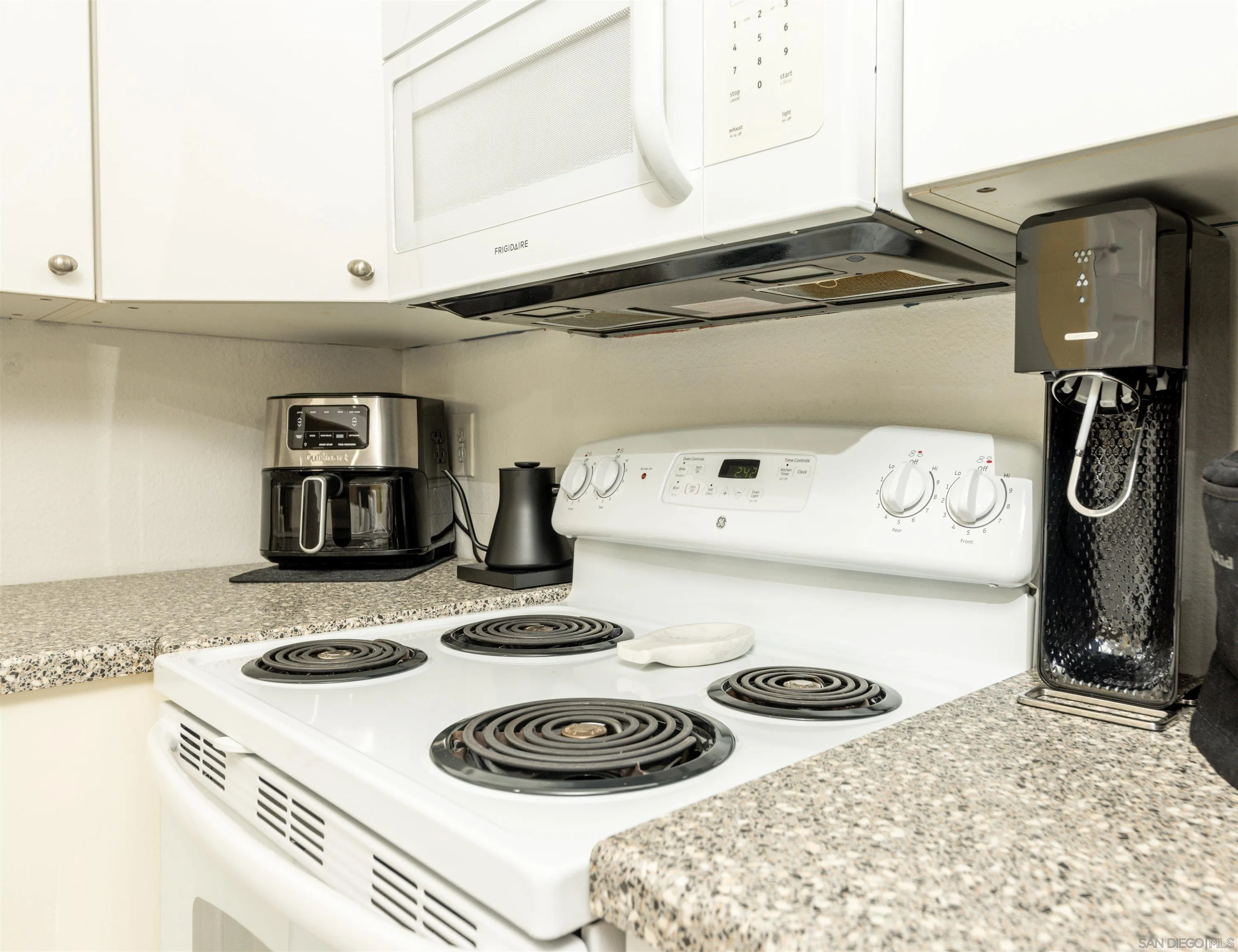3550 Ruffin Road, Unit 155 San Diego, CA 92123 - Photo 10 of 25 a kitchen with a stove and a white refrigerator