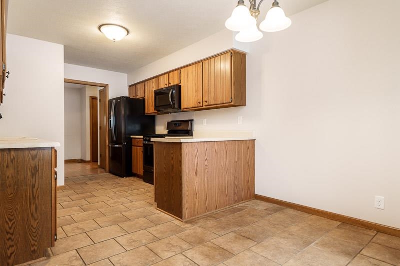 10077 Jesters Row Roscoe, IL 61073 - Photo 12 of 61 a kitchen with stainless steel appliances a refrigerator and a microwave