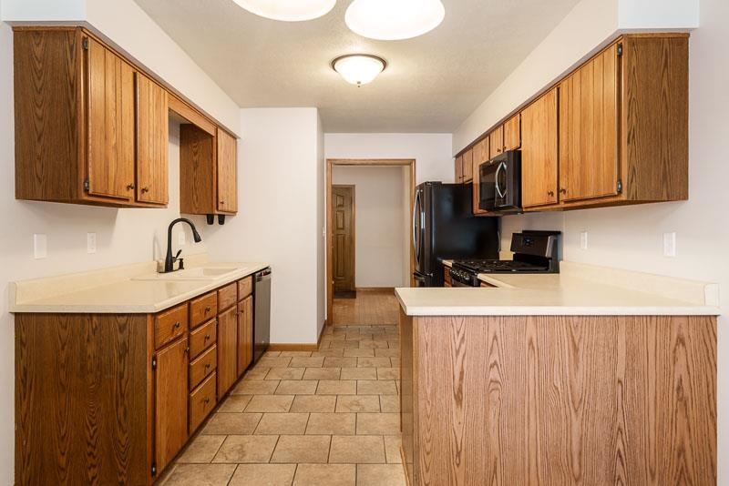 10077 Jesters Row Roscoe, IL 61073 - Photo 13 of 61 a hallway with washer dryer and cabinets