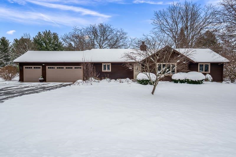 10077 Jesters Row Roscoe, IL 61073 - Photo 2 of 61 a tall house with a large tree in front of it