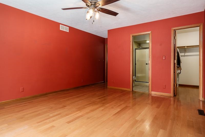 10077 Jesters Row Roscoe, IL 61073 - Photo 23 of 61 an empty room with wooden floor and way to kitchen